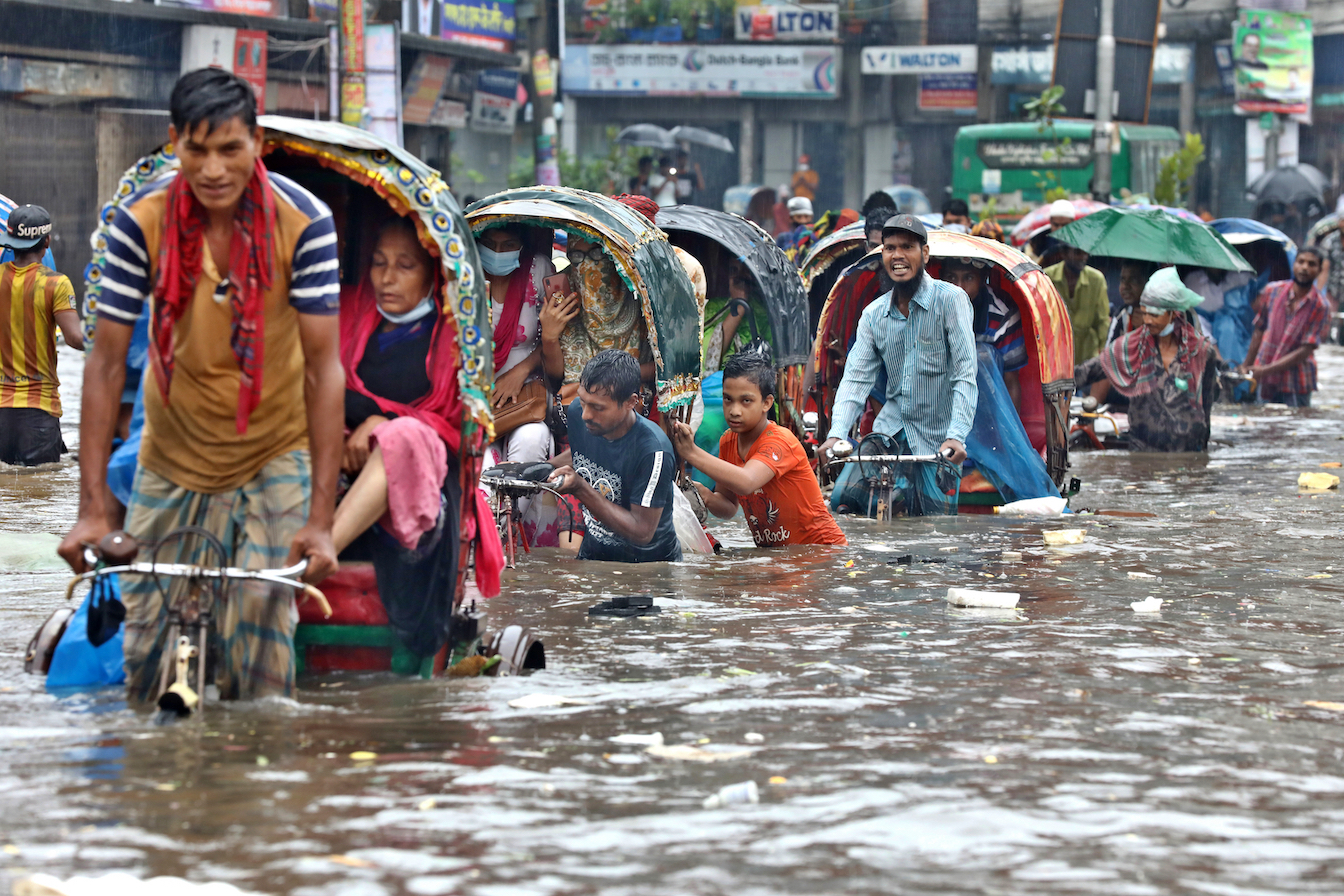 Floods in Bangladesh force residents to move through deep water