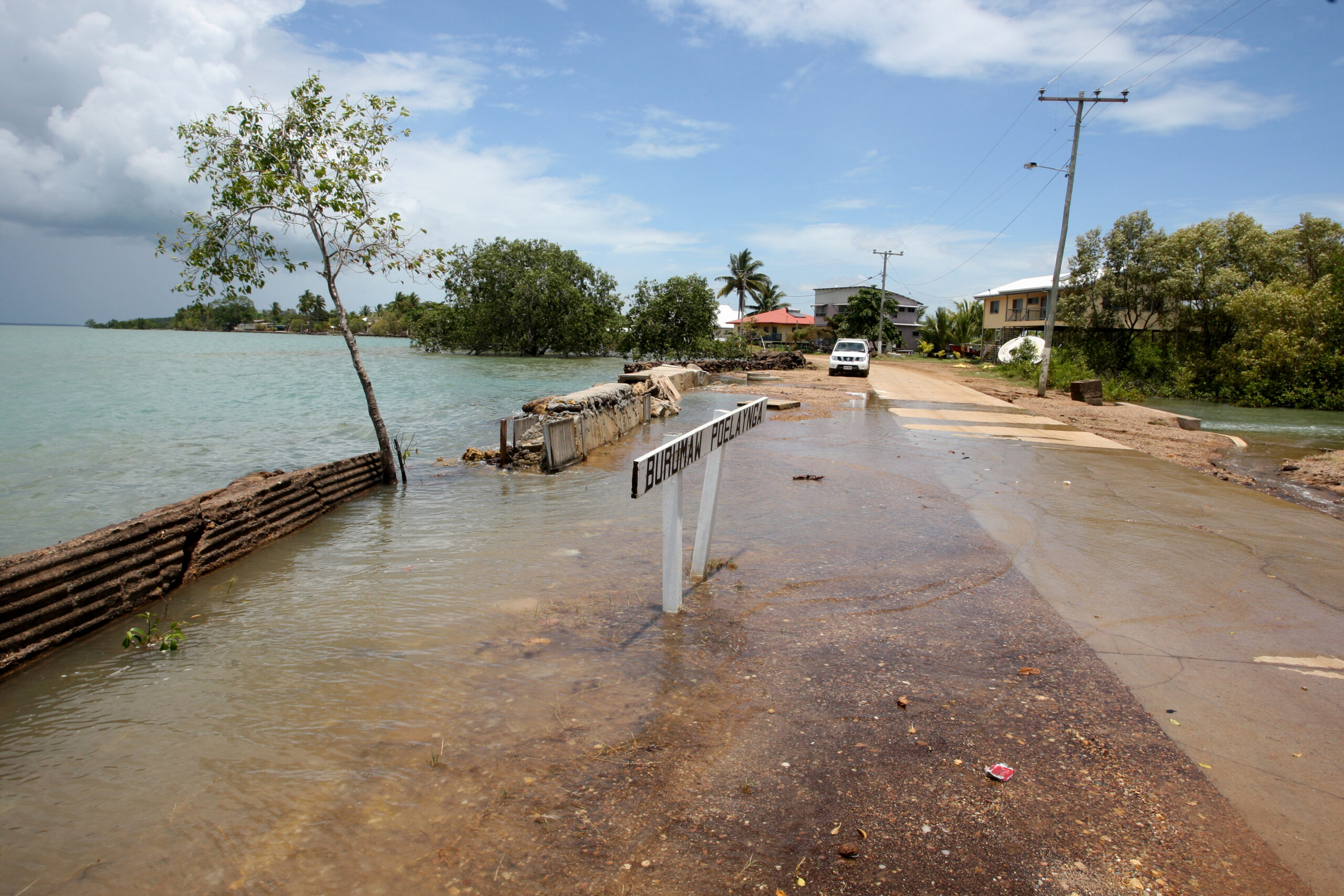 High sea tide floods road on Sabai Island, Torres Strait,
