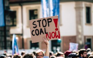 Placard at climate rally 'Stop Coal Now'