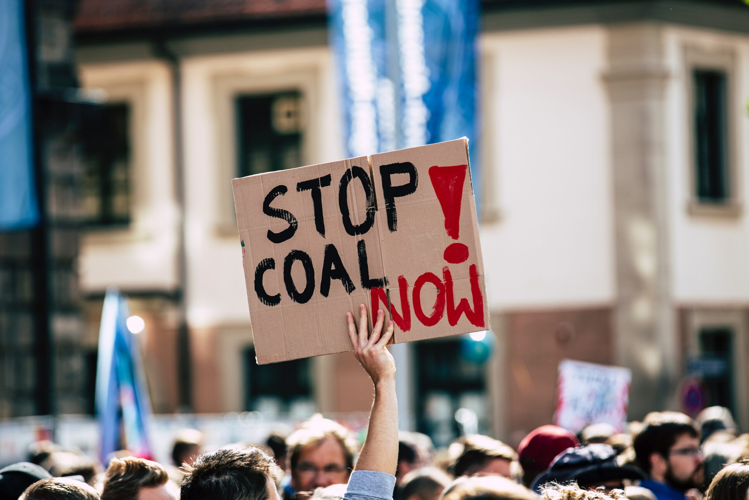 Placard at climate rally 'Stop Coal Now'